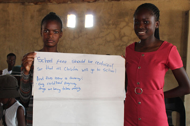 Girls presenting a message during a GWEN TRUST activity